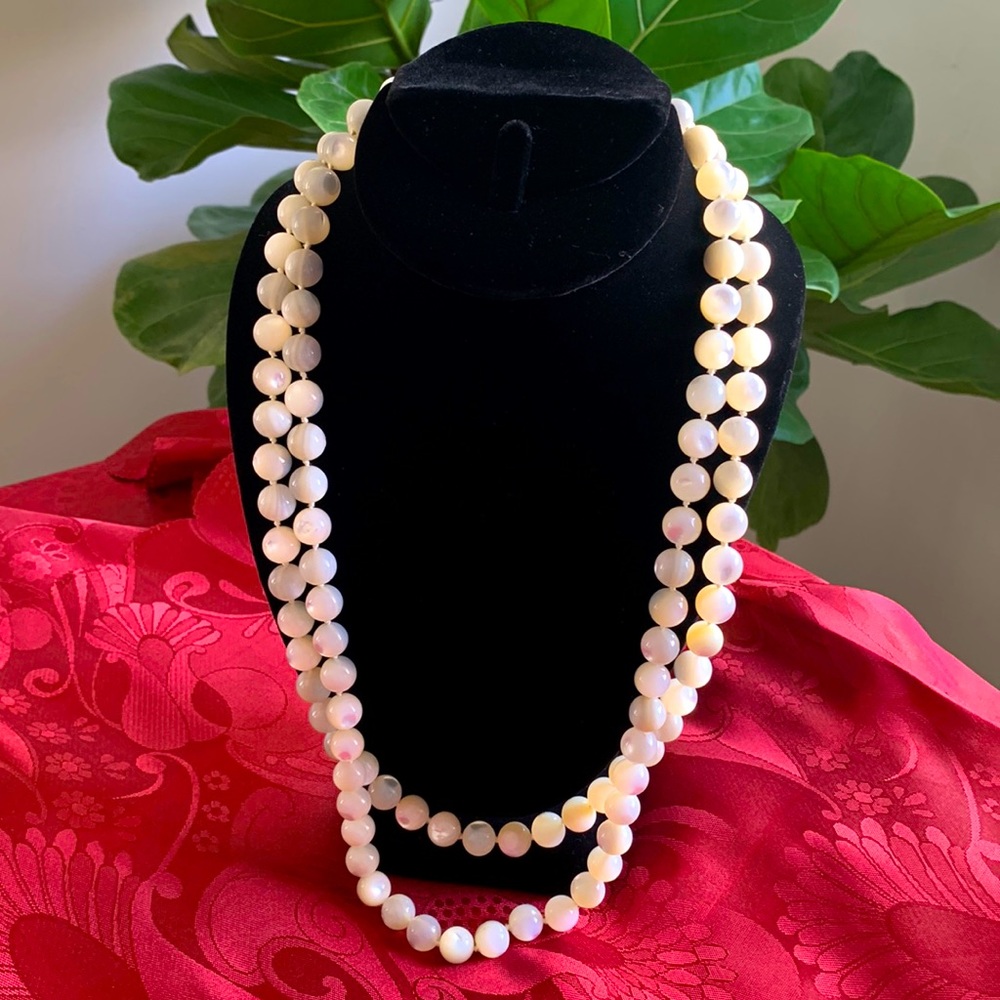 Beautiful Mother of Pearl necklace. Two strands on gold tone clasp.